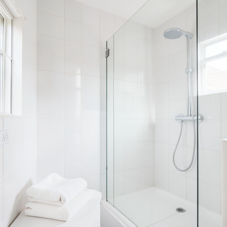 Freshly cleaned bright bathroom with folded towels